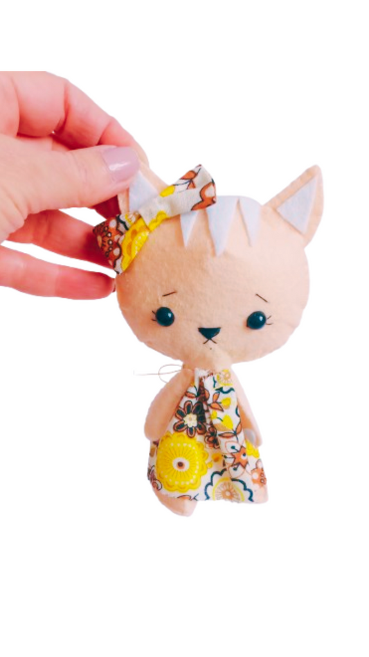 Hand-sewn felt cat doll with embroidered face and floral dress