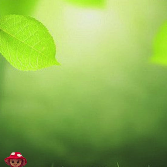 Little red crochet mushroom walks through the grass and swings joyfully – a magical moment from a handmade stop-motion video